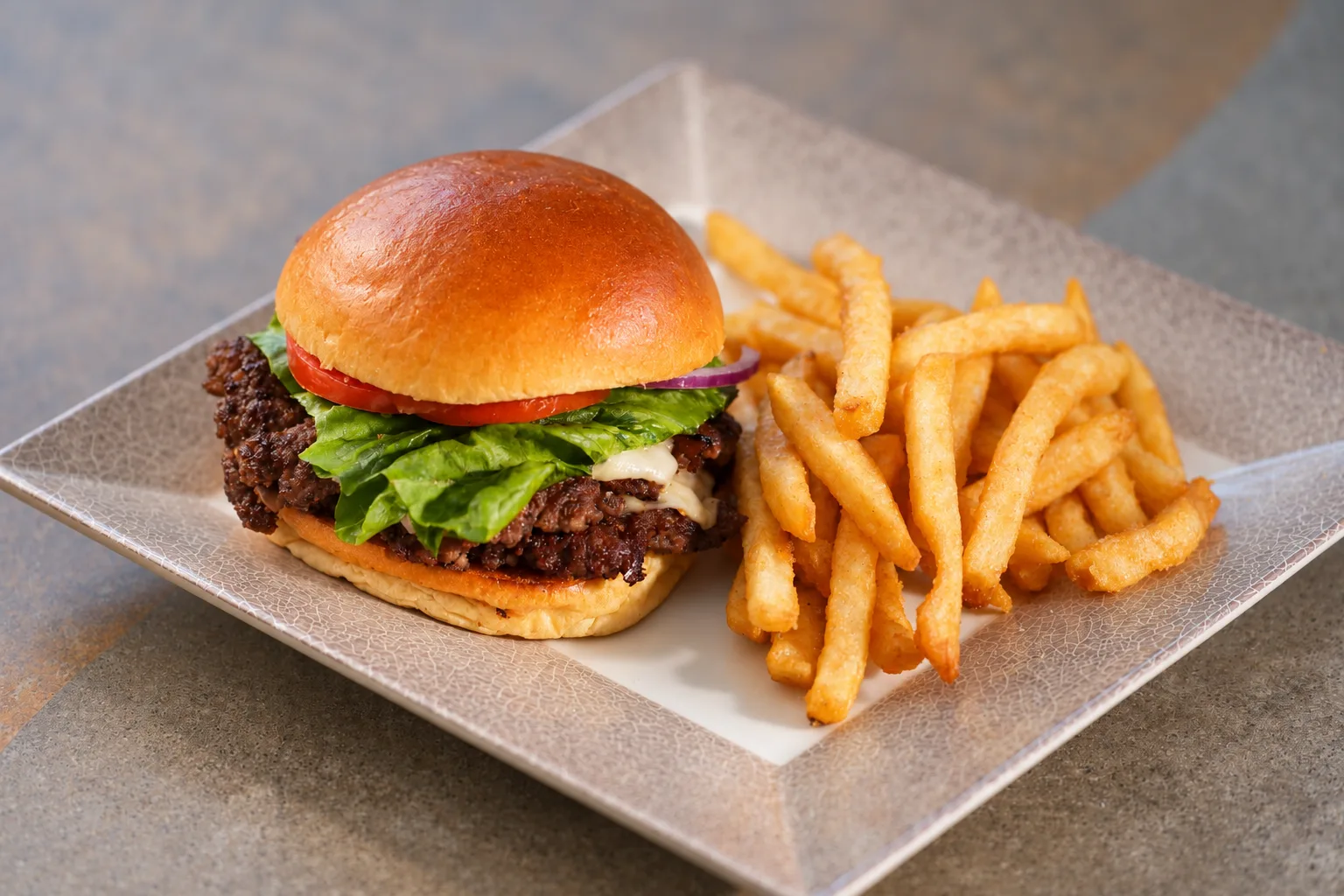 Cheeseburger with lettuce, tomato and fries